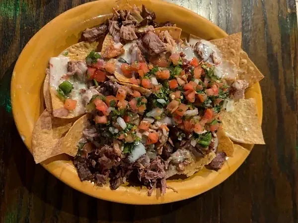 Carnitas nachos with pulled pork, white queso and pico de gallo at El Rancho